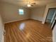 Bedroom featuring wood floors, a ceiling fan and large window at 396 Pitts School Nw Rd, Concord, NC 28027