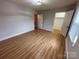 A bedroom featuring wood floors, closet, window, and light fixture at 396 Pitts School Nw Rd, Concord, NC 28027
