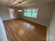 Bright dining room with wood floors and a large window at 396 Pitts School Nw Rd, Concord, NC 28027