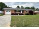 Charming brick ranch-style home with a manicured lawn and fresh landscaping at 396 Pitts School Nw Rd, Concord, NC 28027