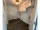 A spacious laundry room features a dark floor, white cabinets, and wainscoting at 396 Pitts School Nw Rd, Concord, NC 28027