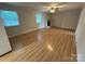 Spacious living room featuring wood floors and a painted brick fireplace at 396 Pitts School Nw Rd, Concord, NC 28027