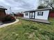 Outdoor shed featuring black trim and a wooden deck, situated in the backyard at 396 Pitts School Nw Rd, Concord, NC 28027