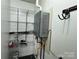 Interior utility room with water heater, wire rack, and painted walls at 396 Pitts School Nw Rd, Concord, NC 28027