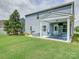 Backyard featuring a covered patio with an outdoor dining area and manicured lawn at 4008 Houndscroft Rd, Indian Trail, NC 28079