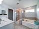 A spacious bathroom featuring a soaking tub, a tiled shower, and double sinks with white cabinetry at 4008 Houndscroft Rd, Indian Trail, NC 28079