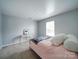 Cozy bedroom featuring neutral carpet, soft decor, and natural light from a window at 4008 Houndscroft Rd, Indian Trail, NC 28079
