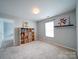 Bright bedroom featuring neutral carpet, shelving, and natural light from a window at 4008 Houndscroft Rd, Indian Trail, NC 28079