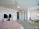 Pink bedroom featuring plush carpeting, two bright windows and a cozy white bed frame at 4008 Houndscroft Rd, Indian Trail, NC 28079