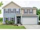 Charming two-story home featuring a two-car garage, gray shutters, and a well-manicured front yard at 4008 Houndscroft Rd, Indian Trail, NC 28079