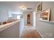 Upstairs hallway with neutral carpet that leads to a laundry room and bedrooms at 4008 Houndscroft Rd, Indian Trail, NC 28079