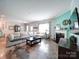 Cozy living room with a fireplace, comfortable seating, and abundant natural light at 4008 Houndscroft Rd, Indian Trail, NC 28079