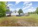 Large backyard with above ground pool, shed, and wooden fence, surrounded by lush greenery at 406 Brentwood Cir, Kannapolis, NC 28081