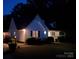 Night view of a cozy home showcasing illuminated exteriors and a beautifully maintained yard, perfect for evening enjoyment at 406 Brentwood Cir, Kannapolis, NC 28081