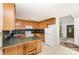 Traditional kitchen with oak cabinets, black countertops, and black and white checkered flooring at 406 Brentwood Cir, Kannapolis, NC 28081