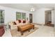 Bright living room with large window, ceiling fan, and neutral carpet with traditional furnishings at 406 Brentwood Cir, Kannapolis, NC 28081
