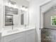 Bright bathroom featuring double sink vanity, modern fixtures, and glass shower at 418 W Westview St, Gastonia, NC 28052