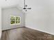 Spacious bedroom with a vaulted ceiling, ceiling fan, wooden flooring, and a large window at 418 W Westview St, Gastonia, NC 28052