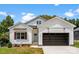 Charming exterior featuring a two-car garage, light blue front door, manicured lawn and craftsman-style details at 418 W Westview St, Gastonia, NC 28052
