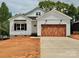 New construction home with white siding, a black roof, a wooden garage door, and an unfinished yard at 418 W Westview St, Gastonia, NC 28052