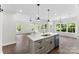 Open-concept kitchen features a large island with a sink, and windows for natural light at 418 W Westview St, Gastonia, NC 28052