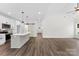 Spacious living room and open kitchen featuring hardwood floors and modern lighting at 418 W Westview St, Gastonia, NC 28052