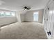Empty bedroom featuring three windows, a ceiling fan, and carpet flooring at 420 Fulton Dr, Kings Mountain, NC 28086