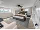 Spacious primary bedroom boasts a ceiling fan, multiple windows, and a decorative area rug at 420 Fulton Dr, Kings Mountain, NC 28086