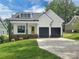 Charming home with a bright yellow door, black garage doors, and a well-manicured lawn at 420 Fulton Dr, Kings Mountain, NC 28086