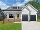 Charming two-story home with a yellow door and a two-car garage at 420 Fulton Dr, Kings Mountain, NC 28086