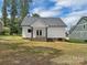A white home exterior with a brick base, a gray roof, and a sprawling green lawn at 420 Fulton Dr, Kings Mountain, NC 28086
