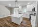 Modern kitchen with white cabinets, a large island, and wood-look floors at 420 Fulton Dr, Kings Mountain, NC 28086