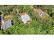 Overhead shot displays a house amid verdant trees, providing a glimpse of its private outdoor spaces at 4290 Palm Dr, Denver, NC 28037