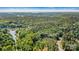Aerial view of wooded property with lake in background at 4290 Palm Dr, Denver, NC 28037