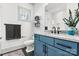 Modern bathroom features a blue vanity with granite countertops, tiled backsplash, and a large mirror at 4290 Palm Dr, Denver, NC 28037