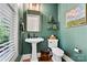 Charming powder room with a pedestal sink, decorative shelves, and elegant gold mirror with fresh, tranquil green walls at 4290 Palm Dr, Denver, NC 28037