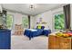 Bright bedroom with Route 66 decor, two windows, a plush blue bed, and carpet floors at 4290 Palm Dr, Denver, NC 28037