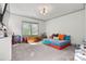 Spacious bedroom featuring carpet floors, a cozy modular couch, and natural light from a window at 4290 Palm Dr, Denver, NC 28037