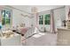 Sunlit bedroom with white and pink accents, large windows, and cozy carpet floors at 4290 Palm Dr, Denver, NC 28037