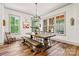 Inviting dining room with a large wooden table, hardwood floors, and natural light for memorable gatherings at 4290 Palm Dr, Denver, NC 28037