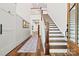 Elegant foyer with hardwood floors, a staircase, white walls, and modern trim for a welcoming entrance at 4290 Palm Dr, Denver, NC 28037
