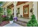 Inviting front porch of home with rocking chairs and decorative plants, perfect for relaxing at 4290 Palm Dr, Denver, NC 28037