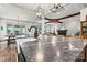 Spacious kitchen island with dark countertops and black fixtures with dining room in background at 4290 Palm Dr, Denver, NC 28037