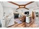 Cozy living room featuring a fireplace, wood beams, shiplap walls, and stylish furniture for relaxing at 4290 Palm Dr, Denver, NC 28037