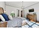 Inviting main bedroom boasts hardwood floors, refined decor, stylish chandelier, and ample natural light at 4290 Palm Dr, Denver, NC 28037