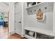 Bright mudroom showcases custom built-ins, coat hooks, and bench seating with storage baskets at 4290 Palm Dr, Denver, NC 28037