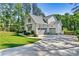 View of home and garage with well manicured lawn and long driveway at 4290 Palm Dr, Denver, NC 28037