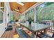 Spacious screened porch with a wood-burning fireplace, dining space and stainless steel grill for outdoor gatherings at 4290 Palm Dr, Denver, NC 28037