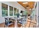 Inviting screened porch with wood-burning fireplace, skylights, and an outdoor dining area for entertaining at 4290 Palm Dr, Denver, NC 28037