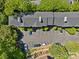 Aerial view of buildings with parking spaces surrounded by mature trees at 430 Queens Rd # 111, Charlotte, NC 28207